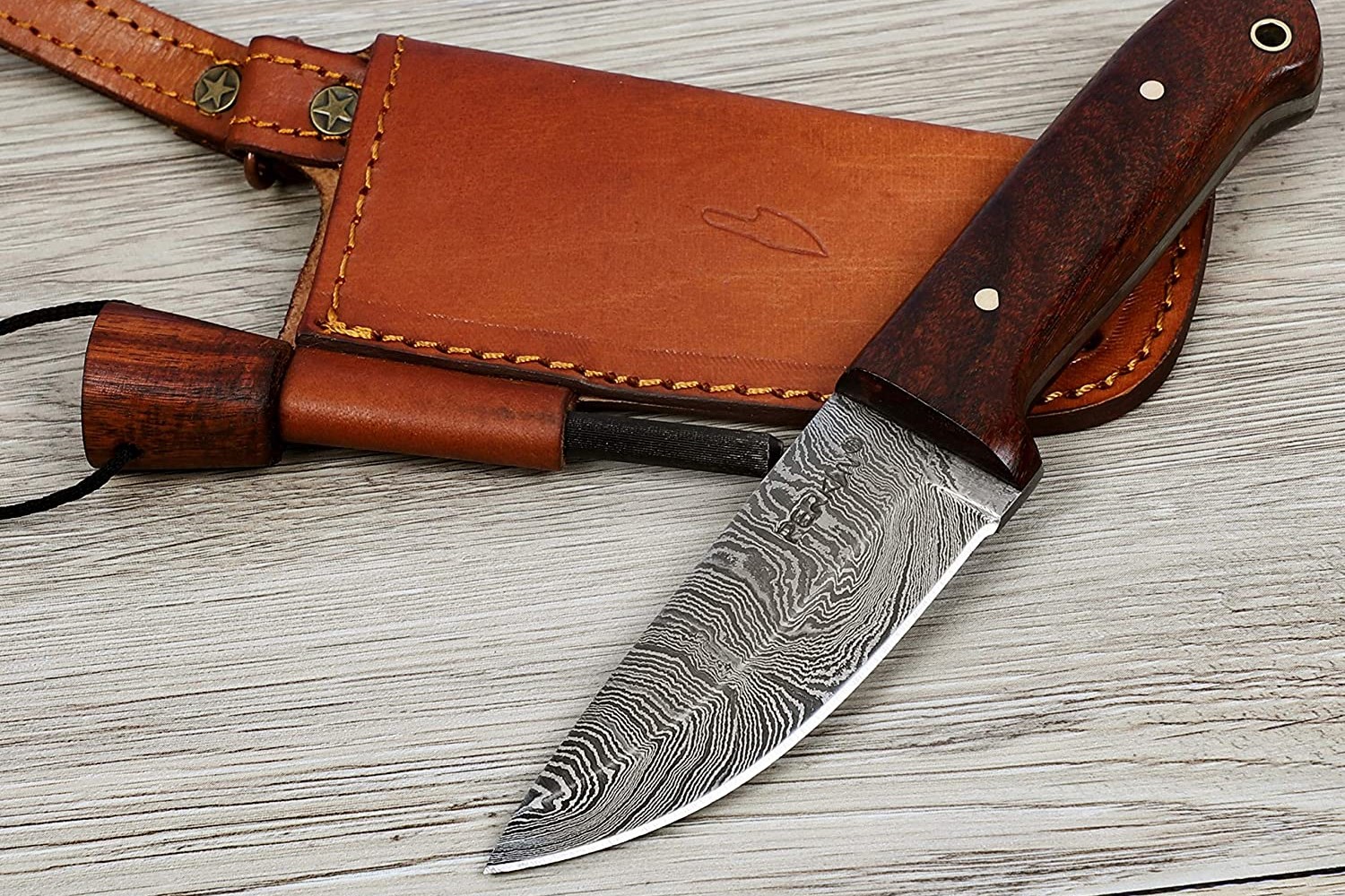 Perkin Custom Handmade Damascus Hunting Knife and a sheath on a wood surface.