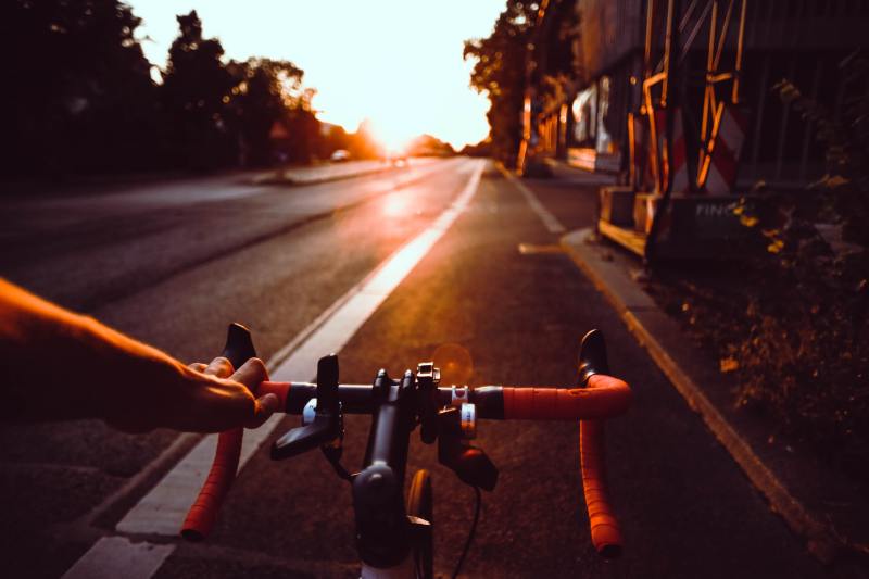 man riding a bike on an open road.