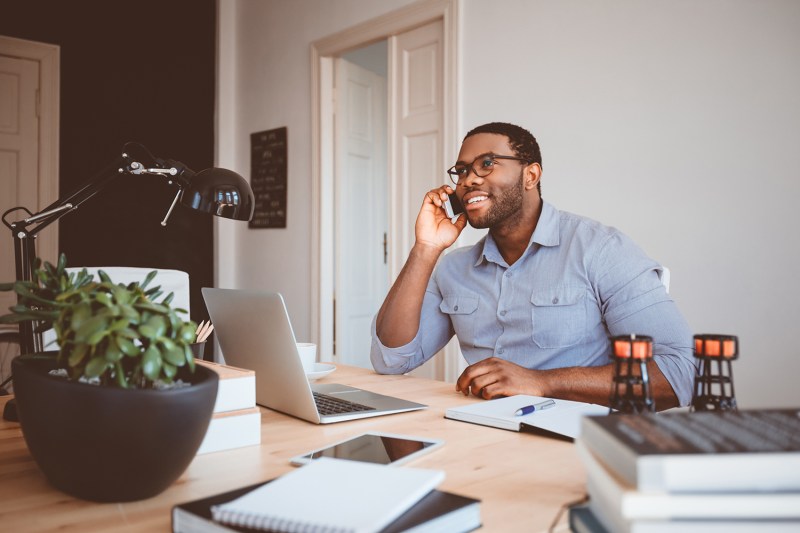 Man making a call while working at home.