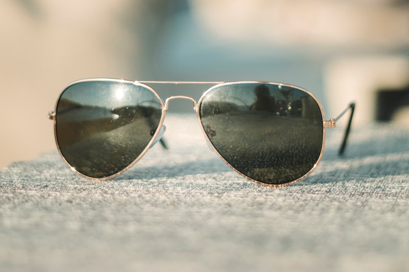A pair of the classic aviator sunglasses with a gold metal frame. 
