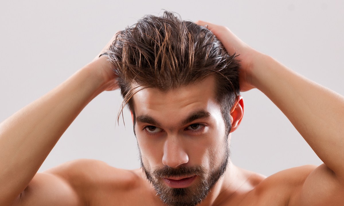 Man putting gel in his hair
