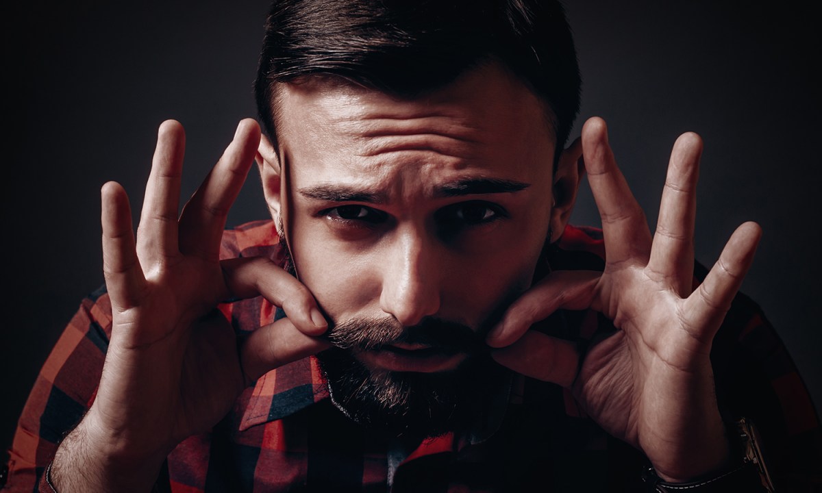 Man waxing his mustache
