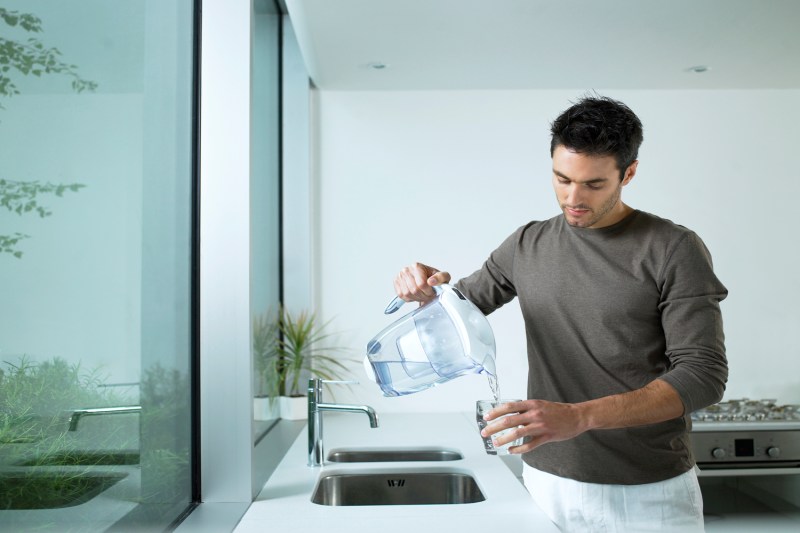 Man pouring a glass of water.