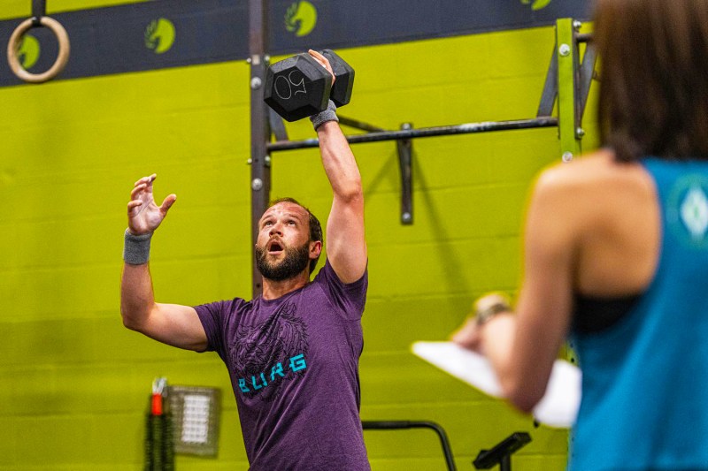 man holding a dumbbell.