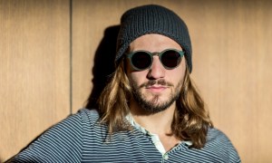 Man with long hair wearing a hat
