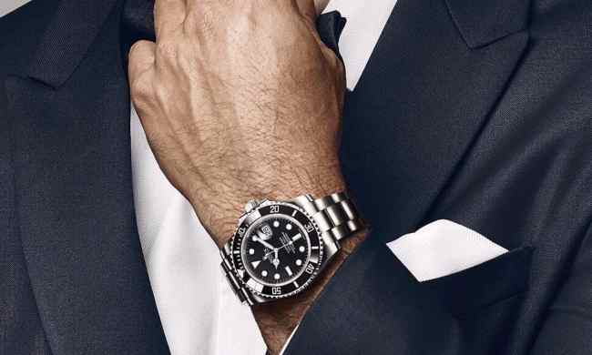 Man wearing a suit and wearing a Rolex.