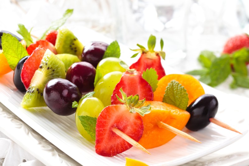 Strawberries. green grapes, kiwi, cherries, and apricots served on a stick