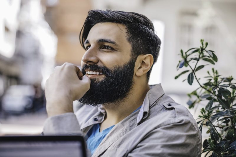 Smiling man with a trim beard.