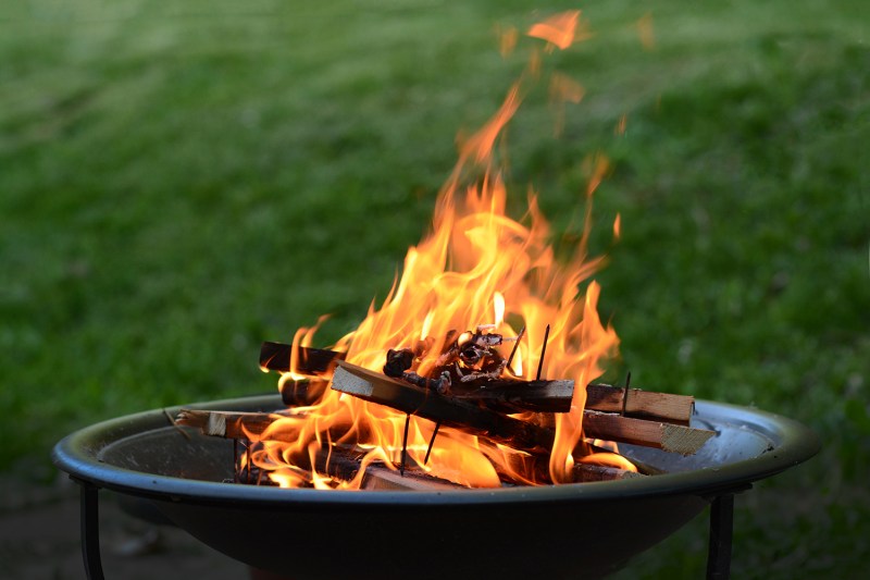 Fire pit burning wood on a patio