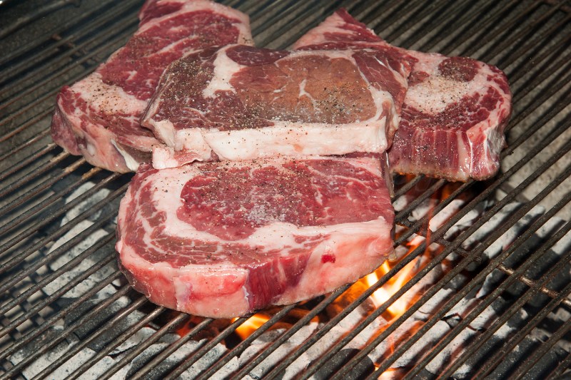 Rib-eye steaks on a barbecue