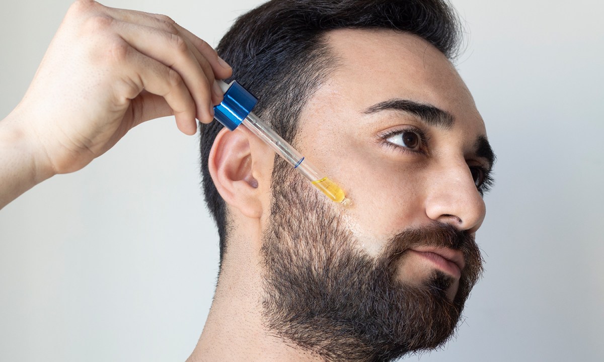 Man using shaving oil