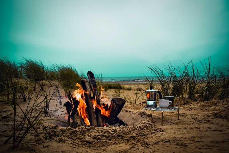 campfire with coffee folding table next to it