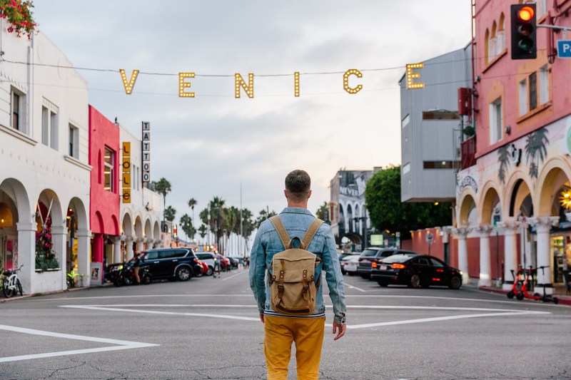 A man standing in the middle of a crossing in L.A.