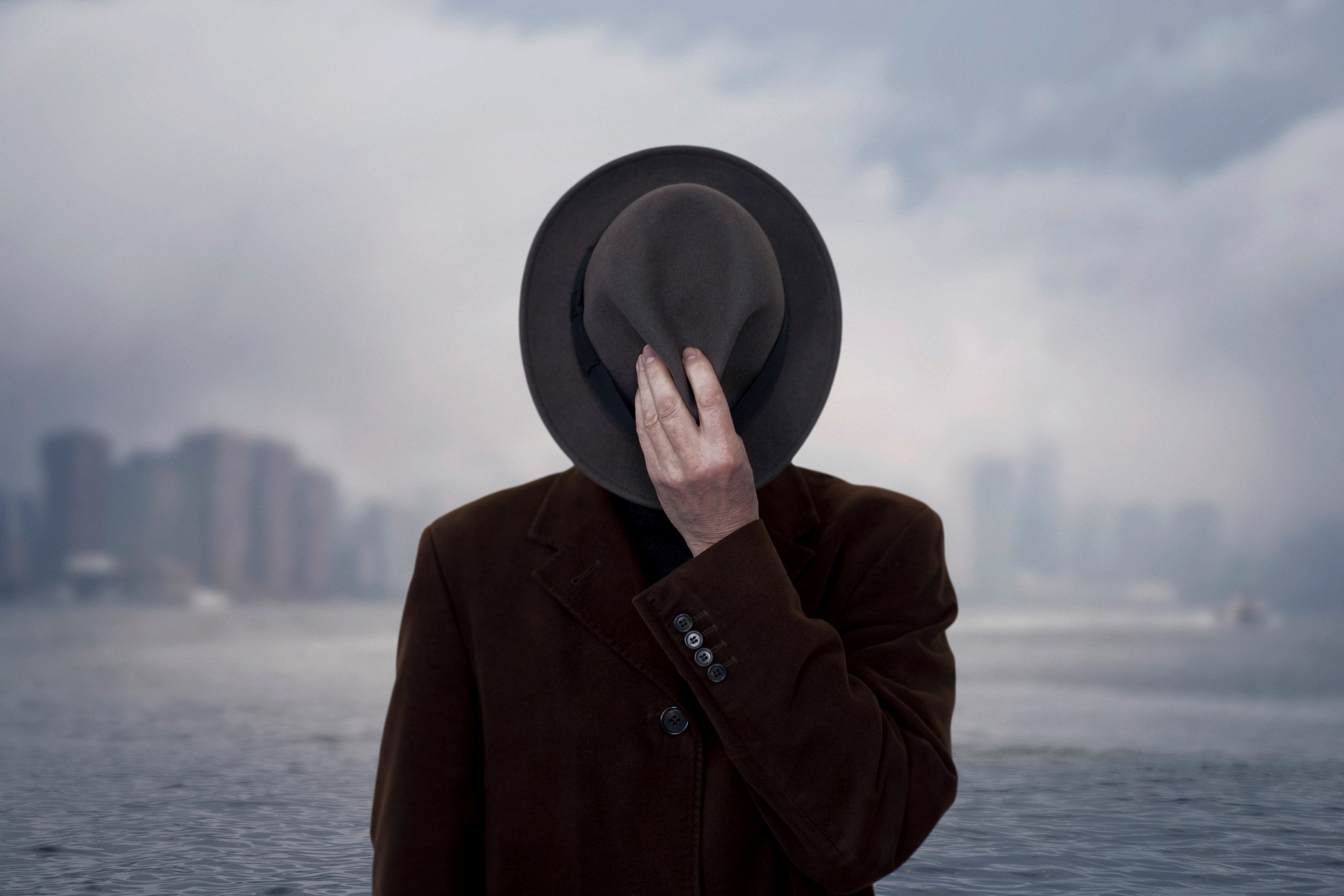 Portrait of a man with face covered by the hat.