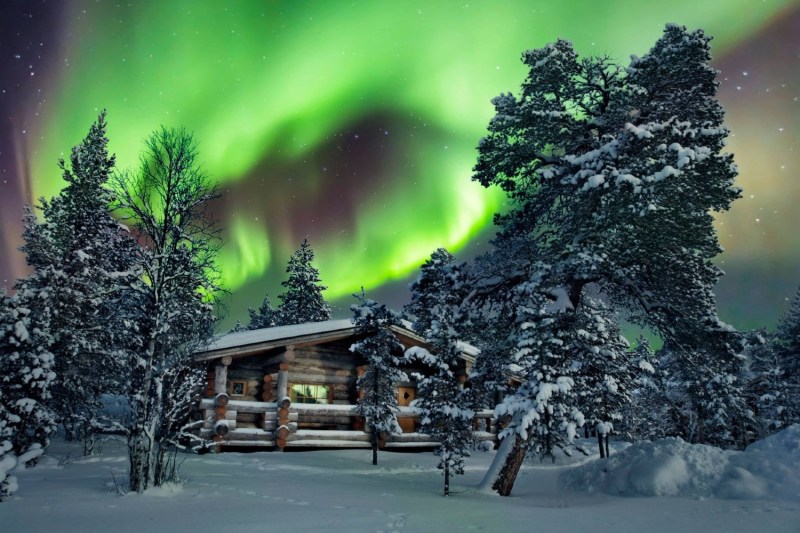 Finnish log cabin with northern lights above