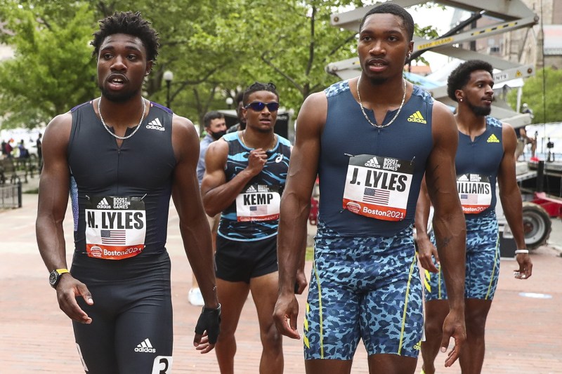 Four men running at a running event.