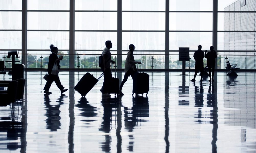 Passengers walking through an airport.