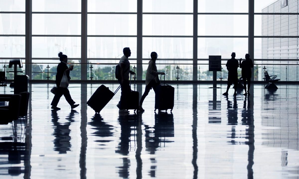 Passengers walking through an airport.