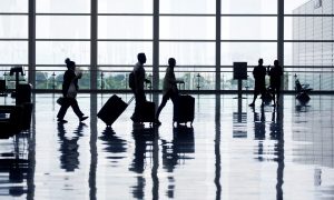 Passengers walking through an airport.