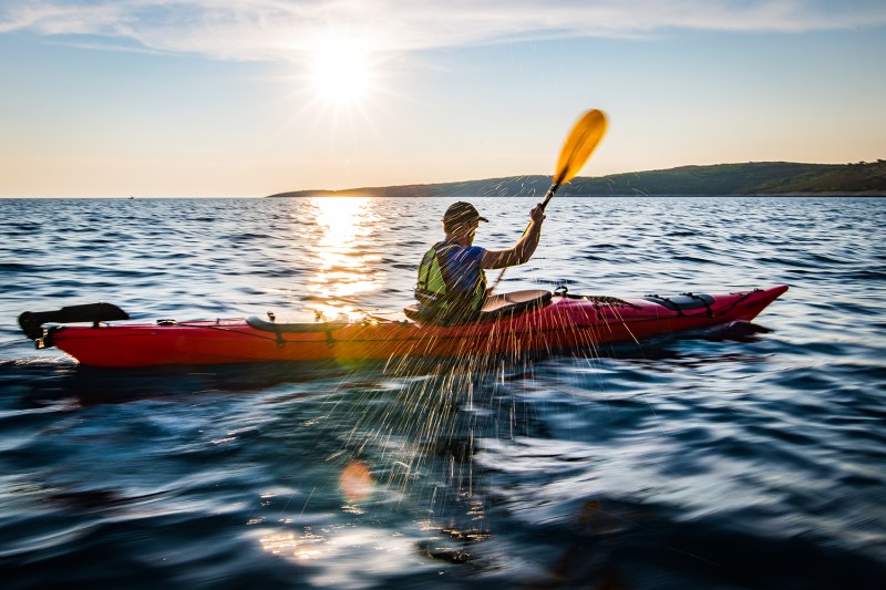 Man paddling in his kayak.