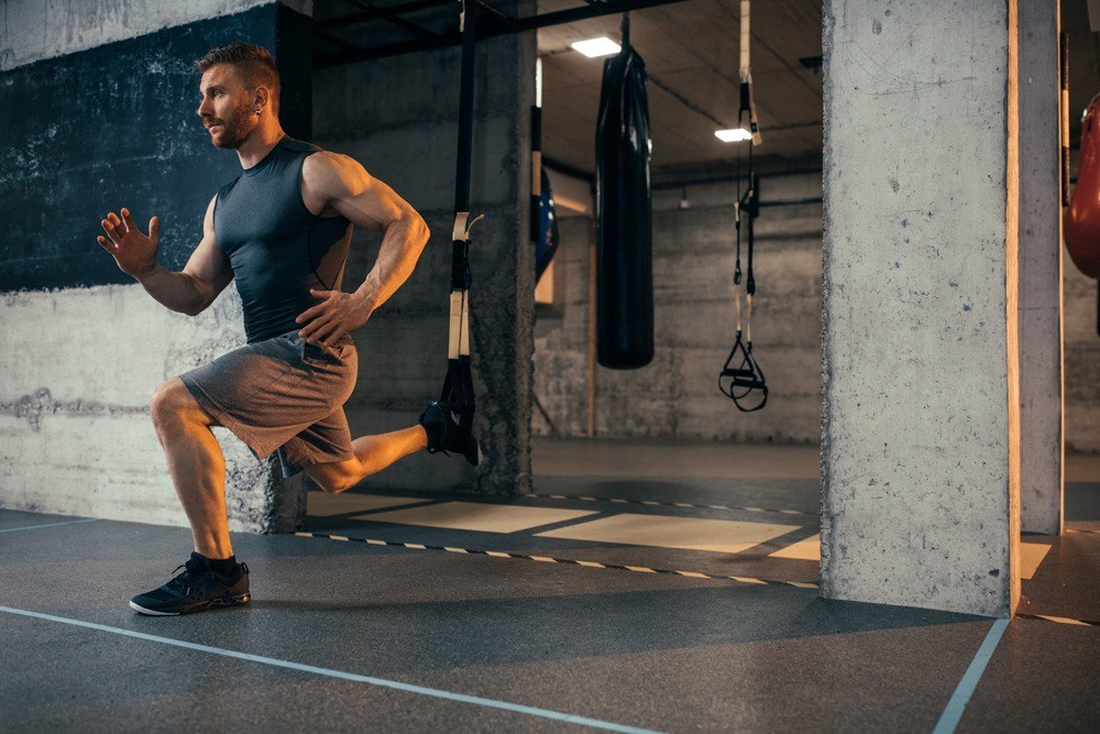 Man doing squats in the gym.