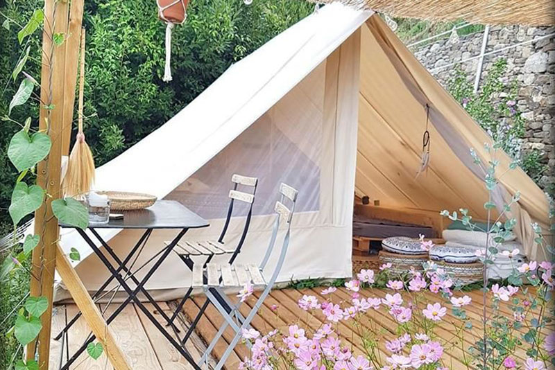 Canvascamp Patrol Deluxe Canvas Tent setup for glamping on a wooden platform.