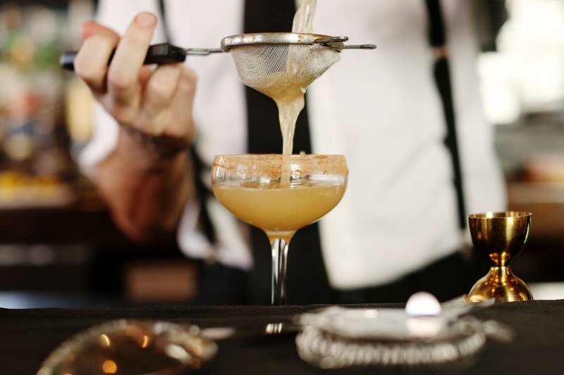 A man preparing a cocktail.