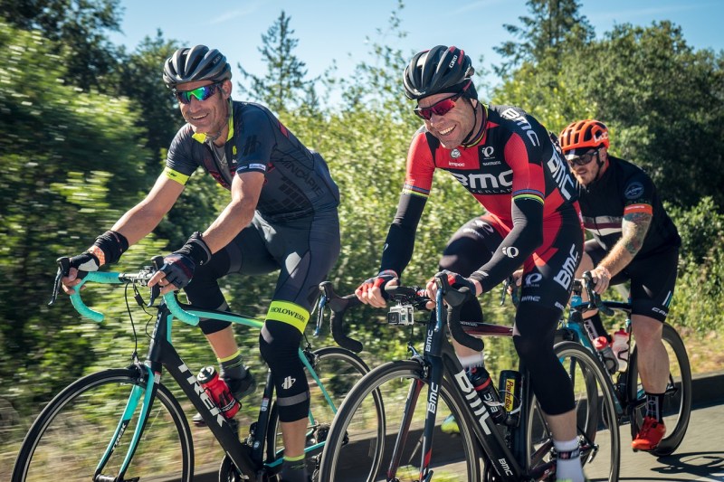 A ground of men cycling ourdoors.