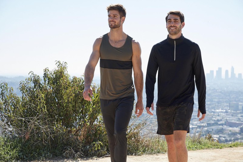 Two guys wearing Fourlaps workout clothes.