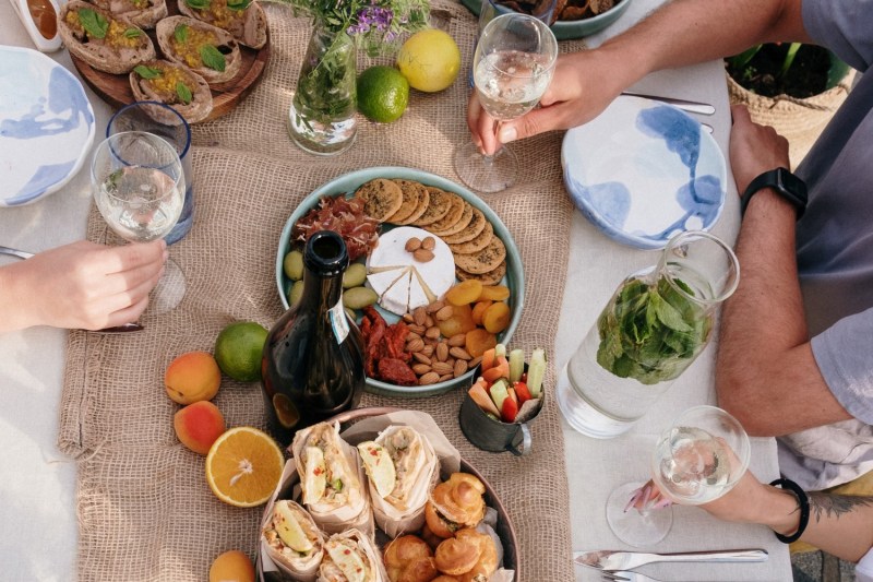 table with appetizers and people sitting around it