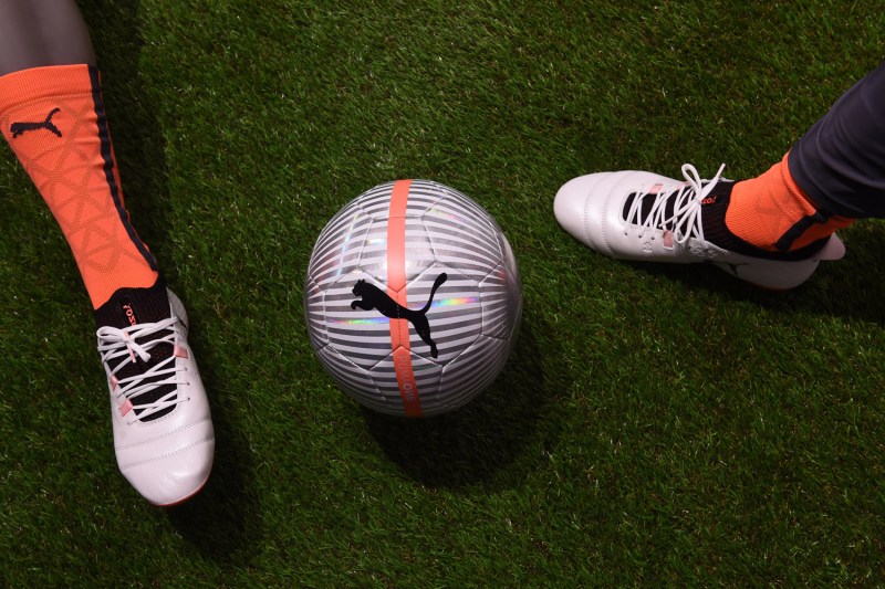 Socks, shoes, and a ball with Puma logo.