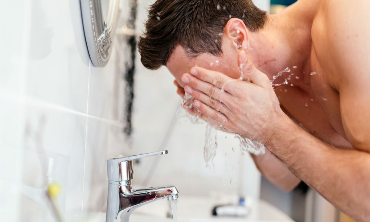 Man washing his face