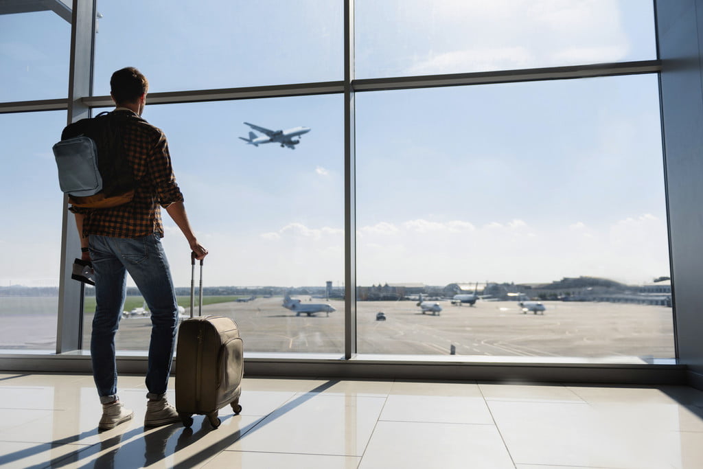 Man waiting for flight at airport.