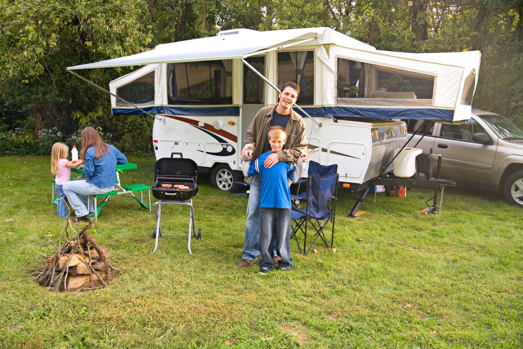 Family outside a pop-up camper