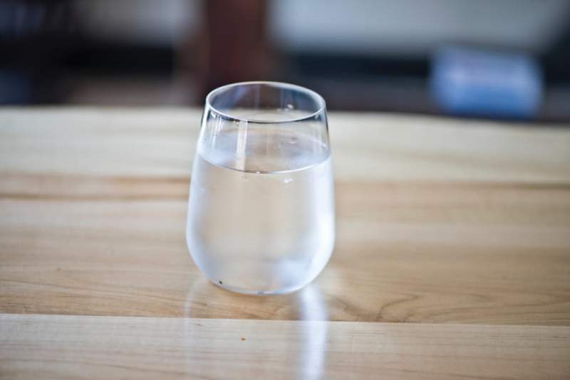 Glass of water on table.
