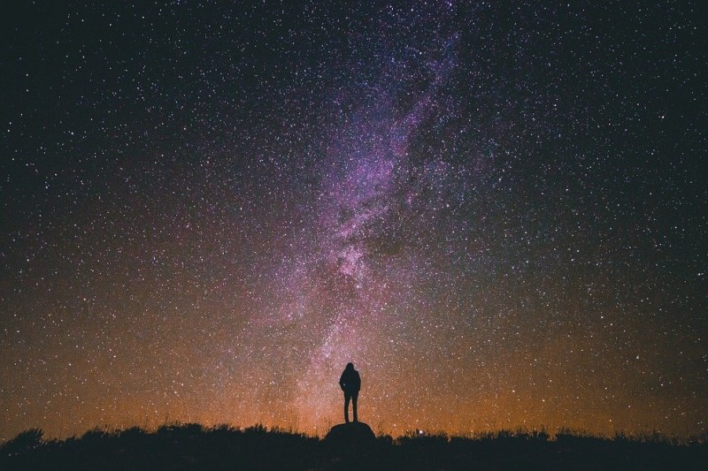 person standing under night sky