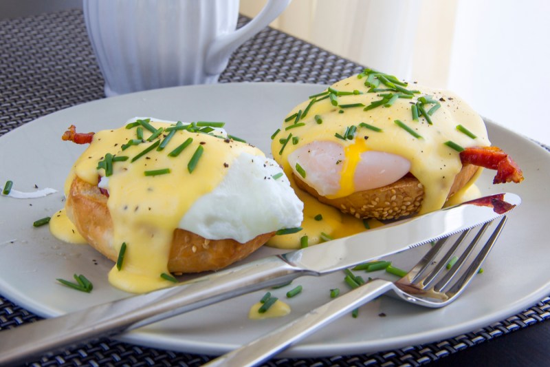 Eggs Benedict. toasted muffins, ham, poached eggs, and delicious buttery hollandaise sauce