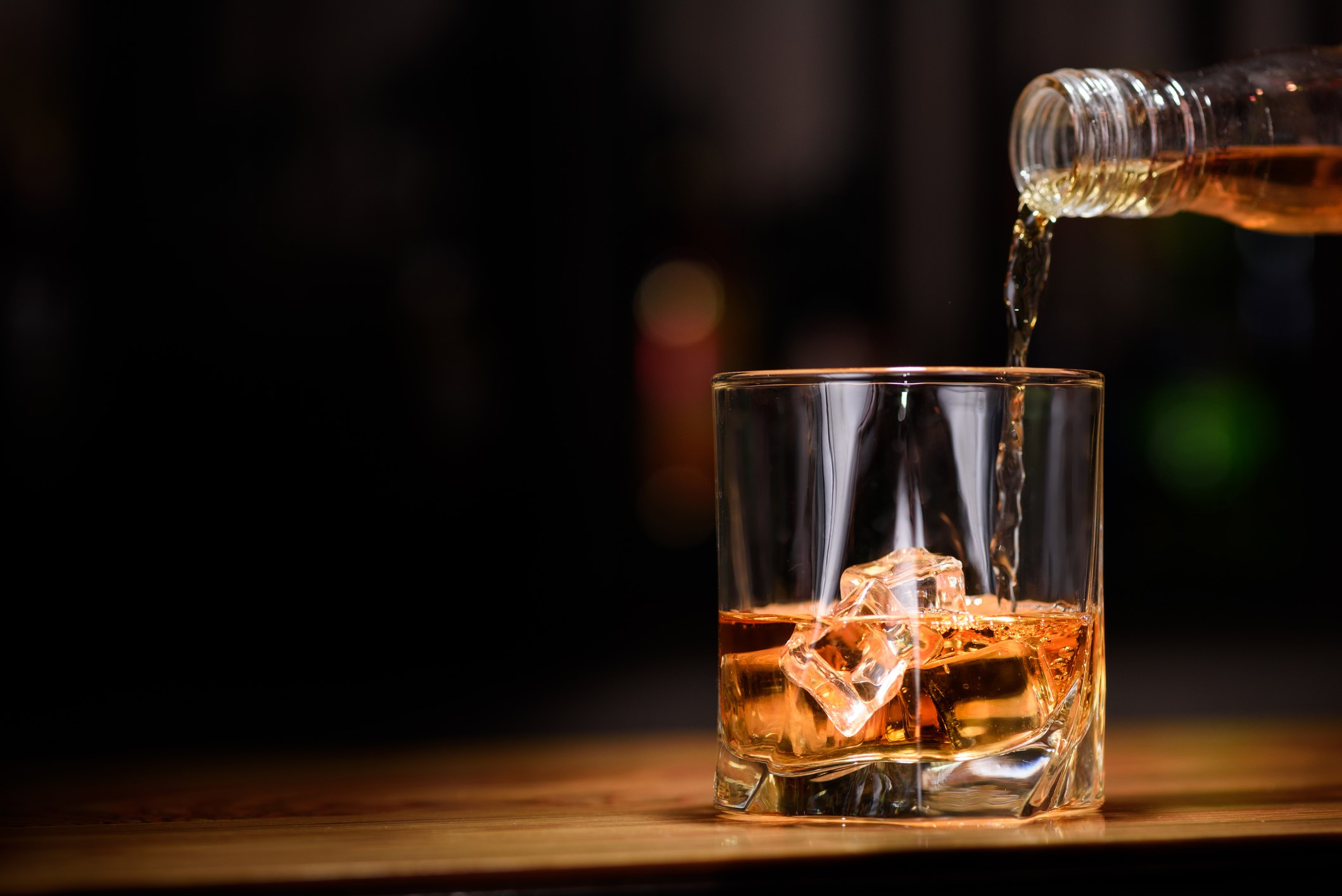 Still life. pour or whiskey in to glass.