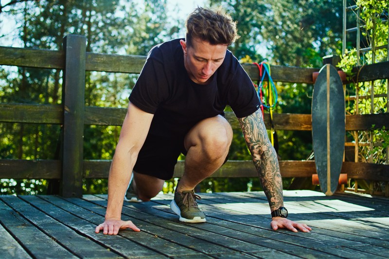 Garden workout. Man doing push ups on a patio