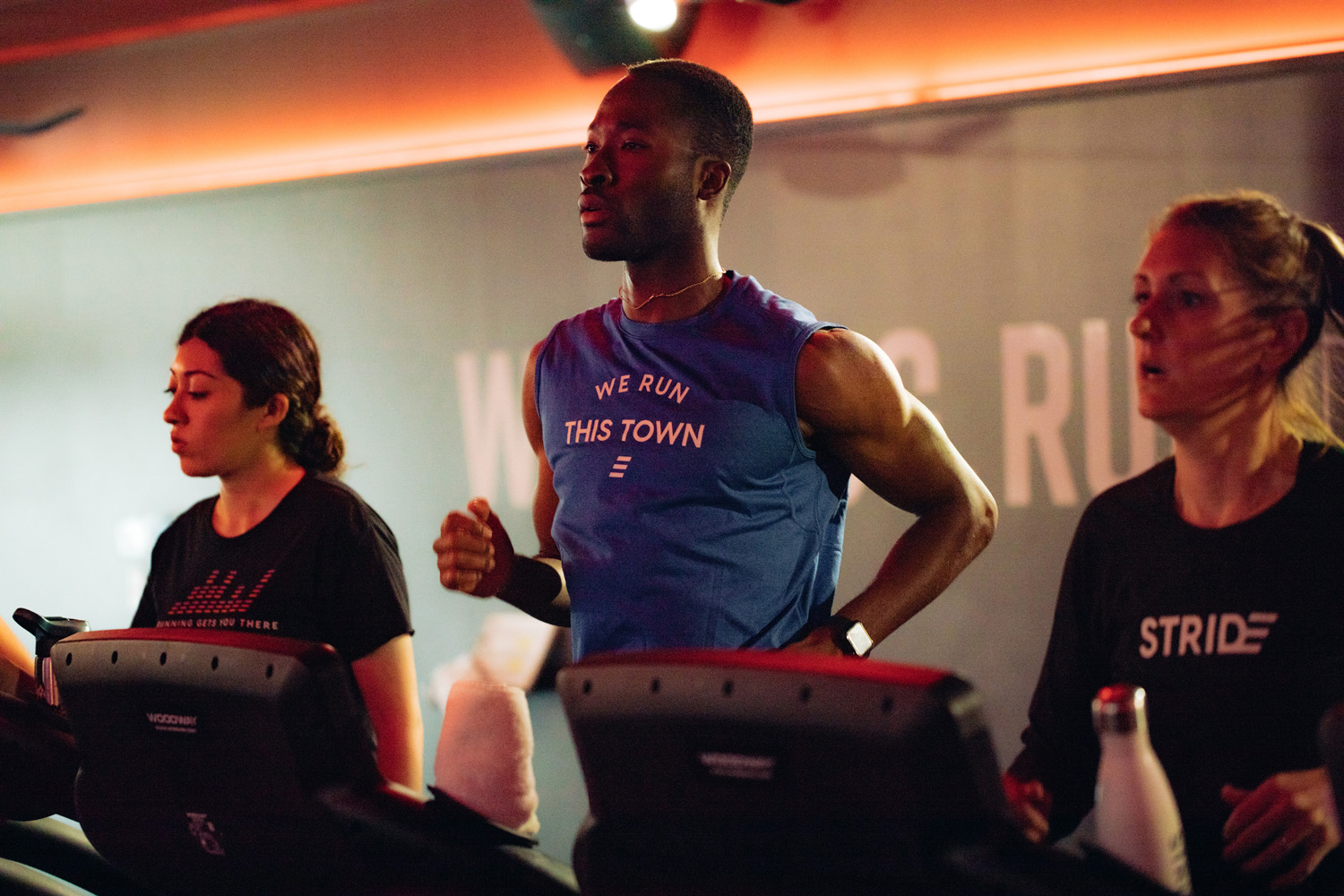 Three athletes running on treadmills at Stride Fitness