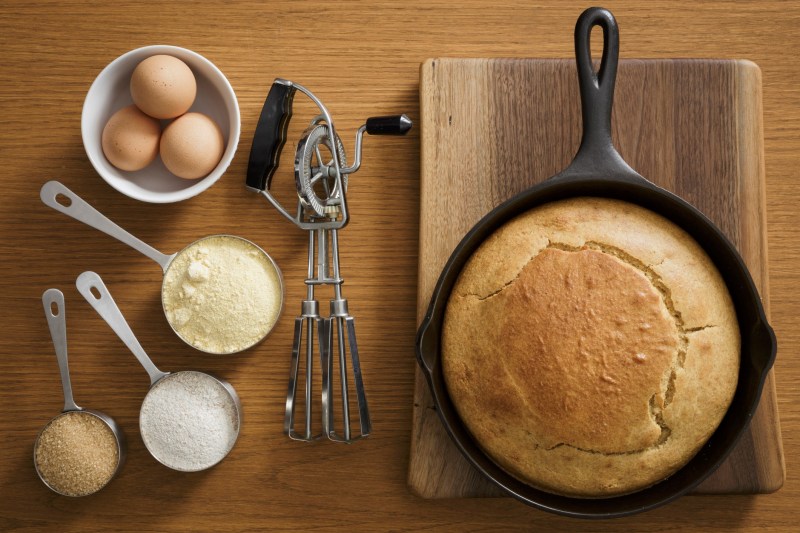 Cornbread in cast iron pan with ingredients.