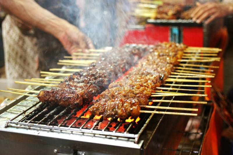 Meat skewers being grilled.