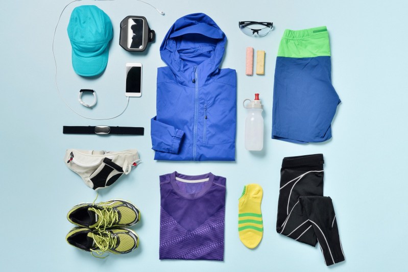 Men's wardrobe essentials organized in a blue backdrop.