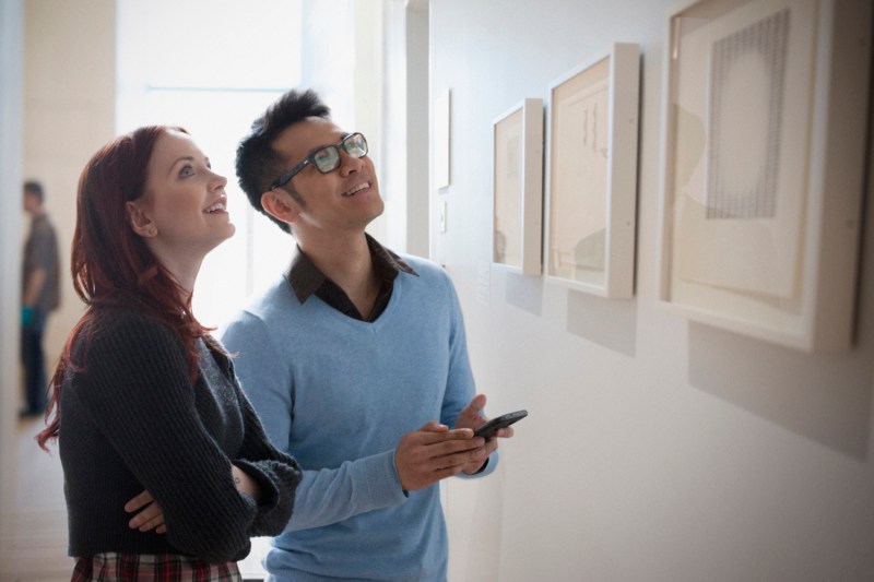 A couple admiring artwork in an art gallery.