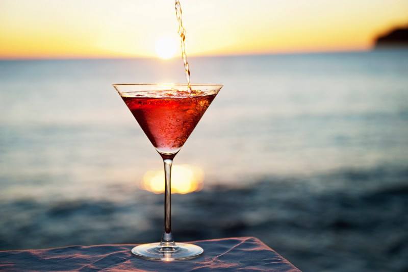 Cocktail pouring in glass outdoors