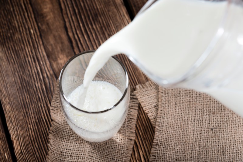 A portion of Milk on a dark wooden background.