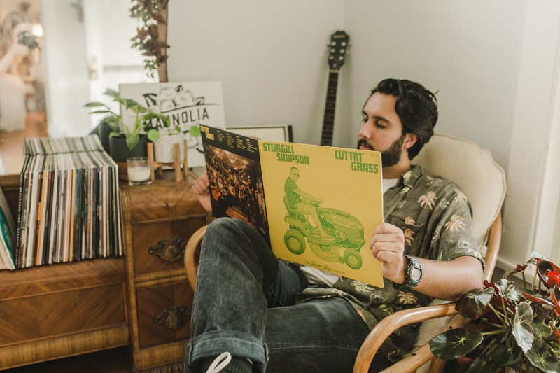 A man reading a vinyl album inside Magnolia store