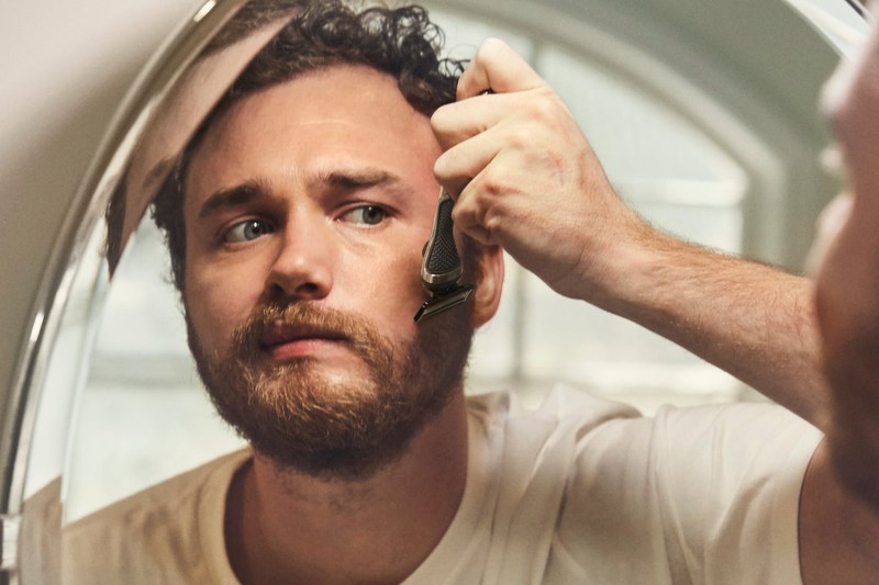 A man shaving his face.