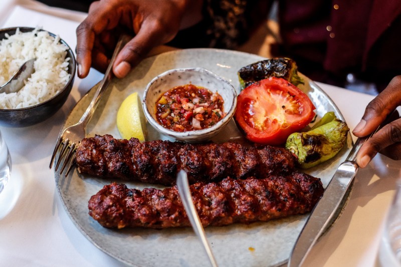 Turkish Adana kebab plate with grilled vegetables.