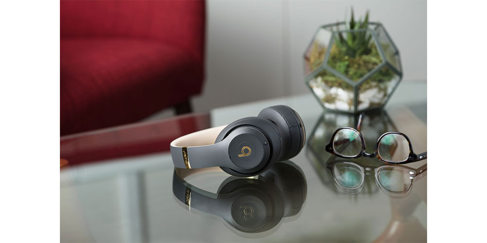 Beats Studio 3 Wireless Noise Cancelling Headphones placed on a countertop with a plant nearby.